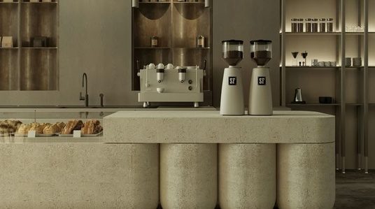 Bar mit Steintresen, Espressomaschine und Pâtisserie-Vitrine